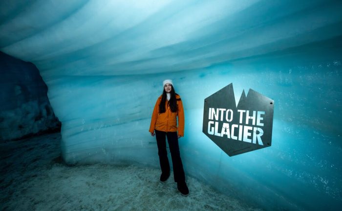 Female traveller inside Into The Glacier ice tunnel in Langjokull glacier.
