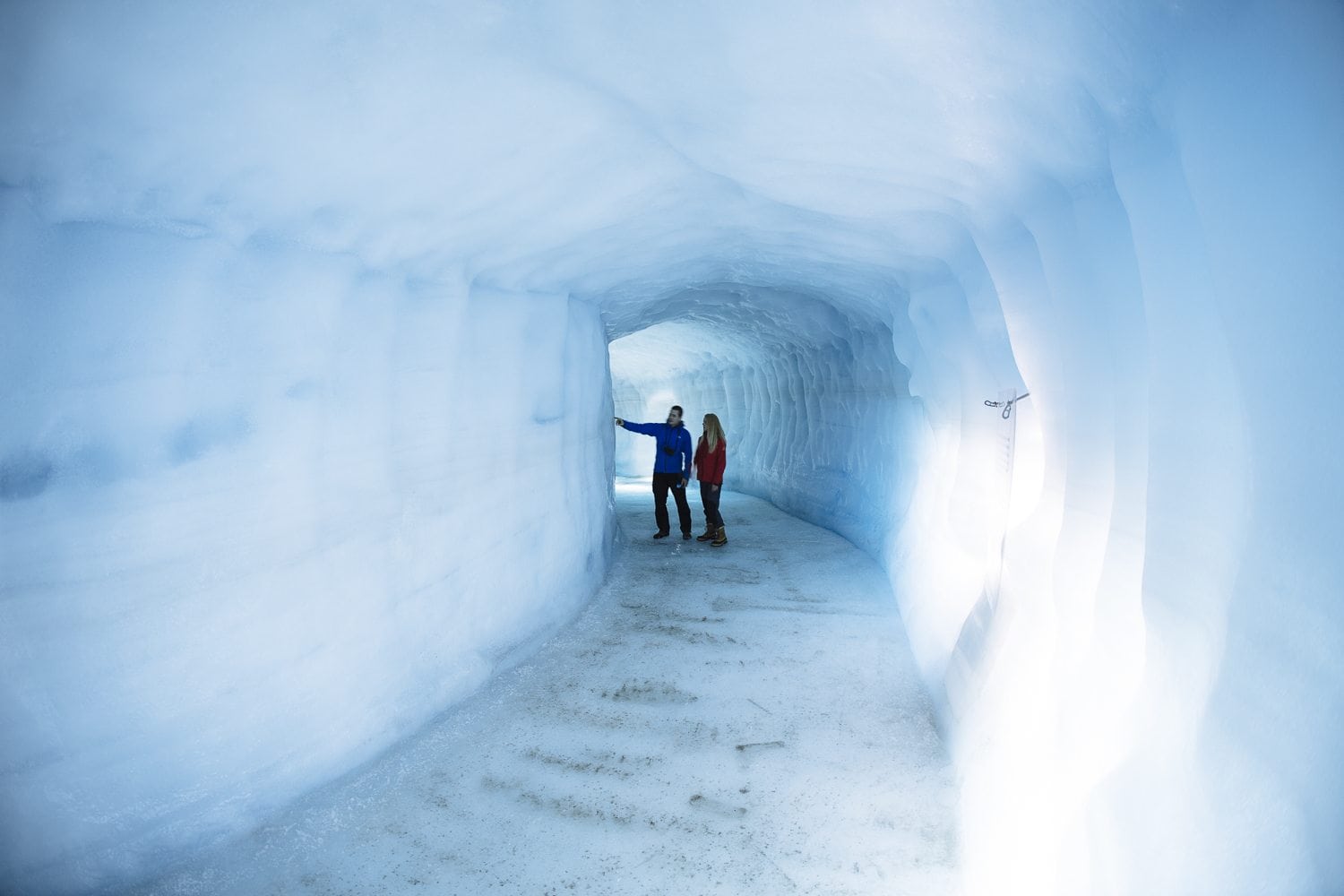 a couple in an ice tunnel
