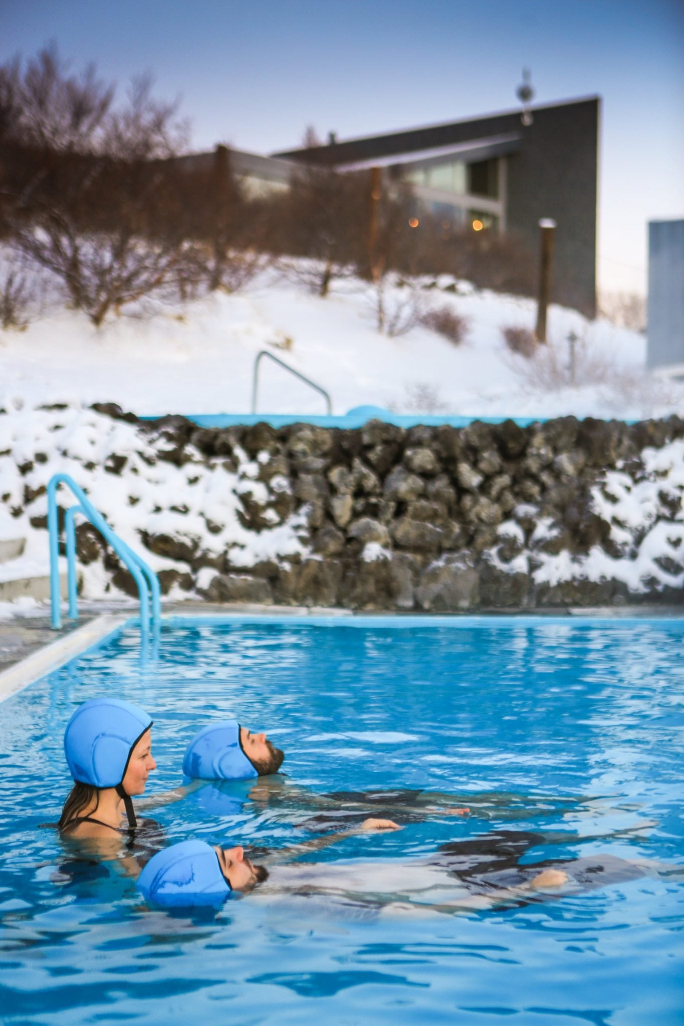people swimming in an geothermal pool in winter