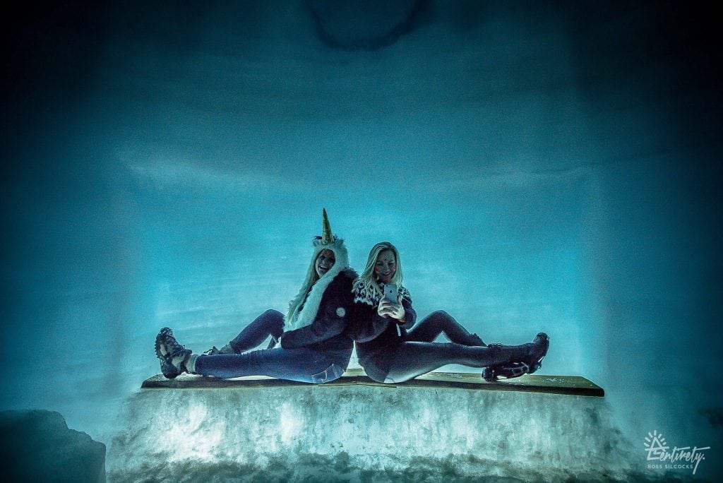 Girls taking picture inside ice tunnel