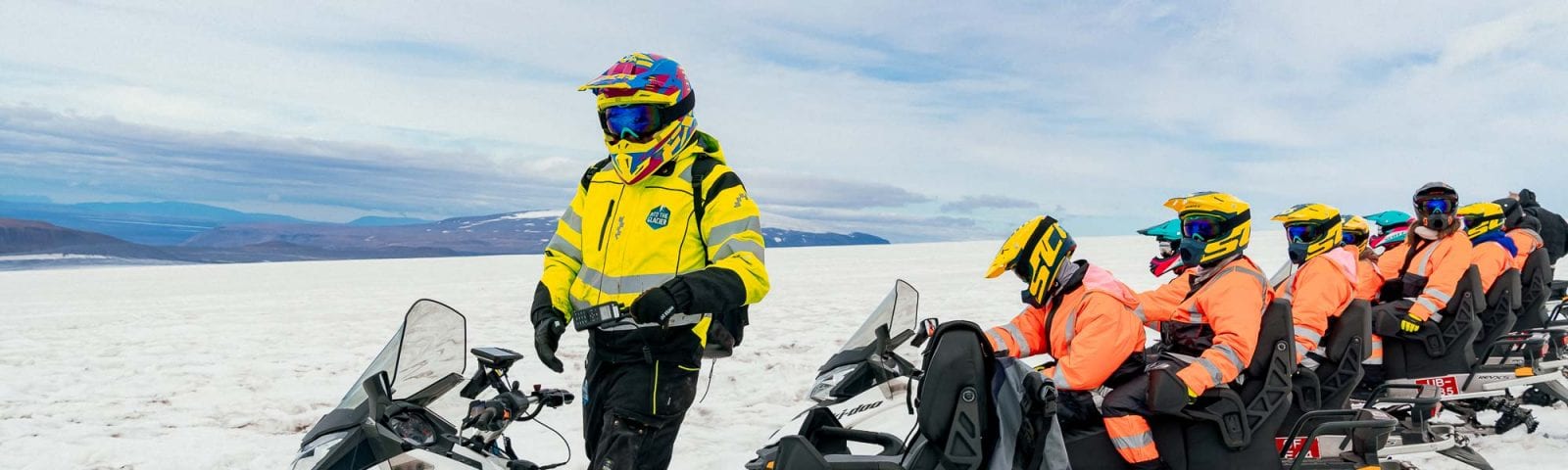Group of people ready to snowmobile on glacier