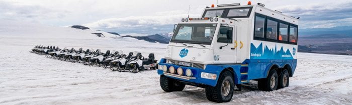 Snowmobile and truck on a glacier