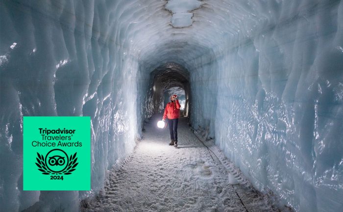 Woman in long ice cave on glacier